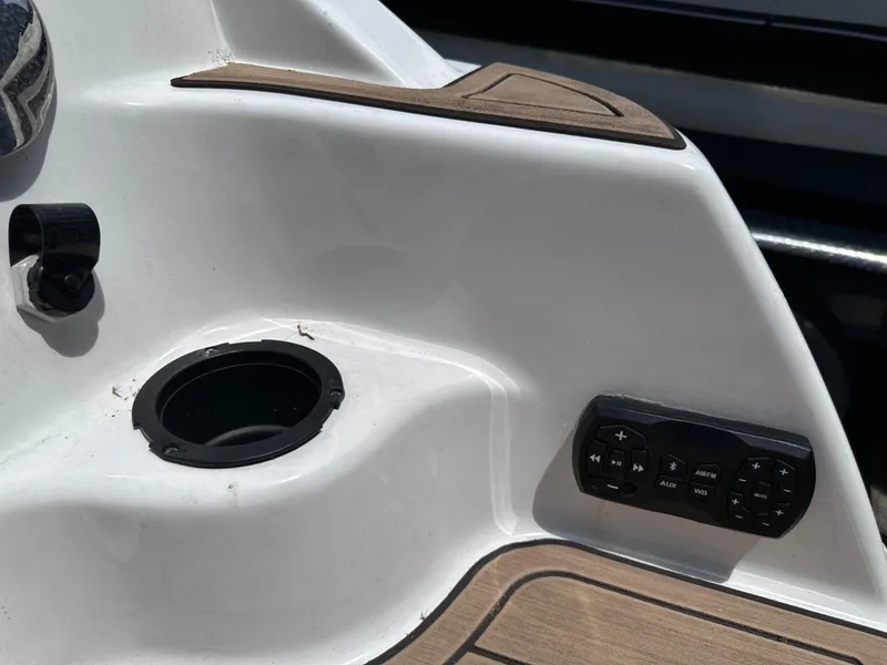 Slide: The Image of Close-up of 2021 Yamaha Boats 252 SD control panel and cup holder. - 45