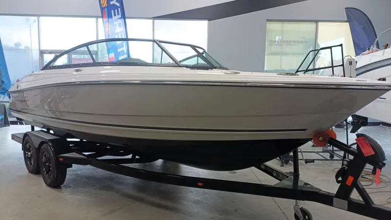 Slide: The Image of 2025 Monterey 224FS boat on trailer in showroom. - 11