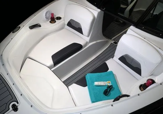 Slide: The Image of 2025 Monterey 224FS boat interior with white seating, teal towel, and sunscreen. - 15