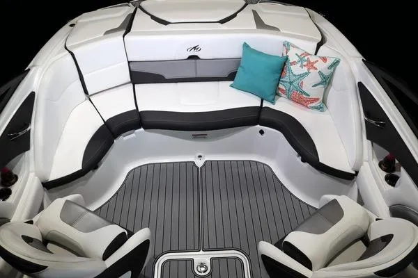 Slide: The Image of 2025 Monterey 224FS boat interior with cushioned seating and decorative pillows. - 17