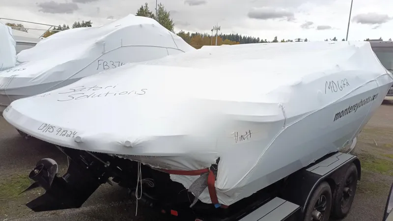 Slide: The Image of 2025 Monterey 224FS boat covered in protective wrap on a trailer. - 23