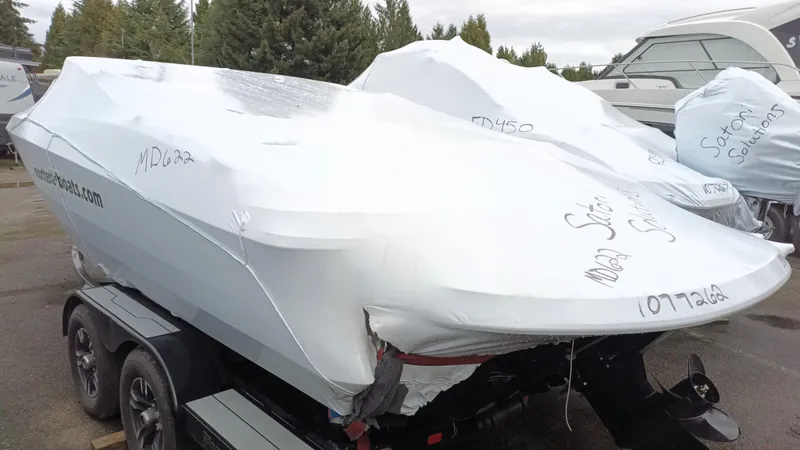 Slide: The Image of 2025 Monterey 224FS boat covered in protective wrap on a trailer. - 25