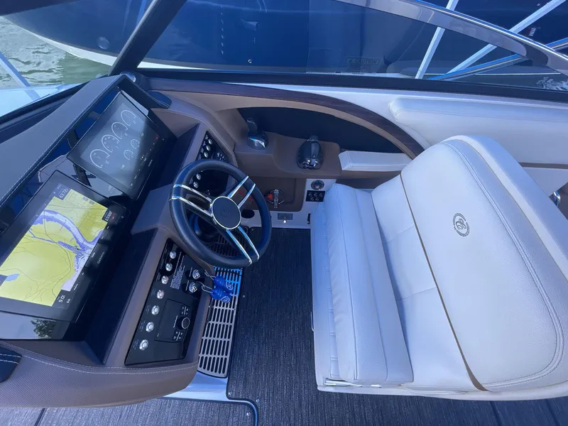 Slide: The Image of 2021 Cobalt R30 boat helm with modern navigation displays and luxurious seating. - 13