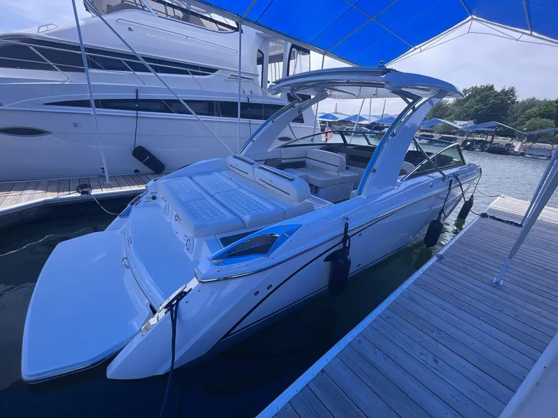 Slide: The Image of 2021 Cobalt R30 boat docked under a blue canopy at a marina. - 5