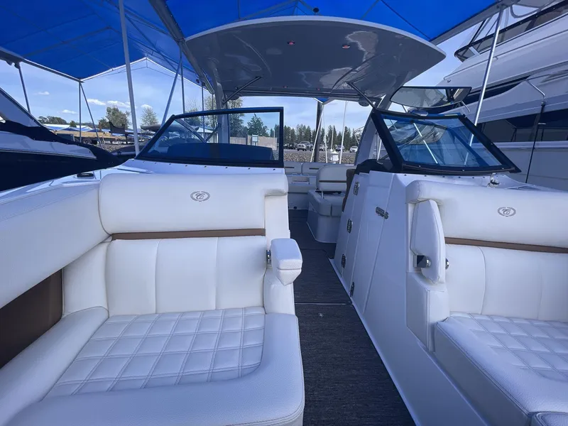 Slide: The Image of 2021 Cobalt R30 boat interior with white seating and blue canopy. - 9