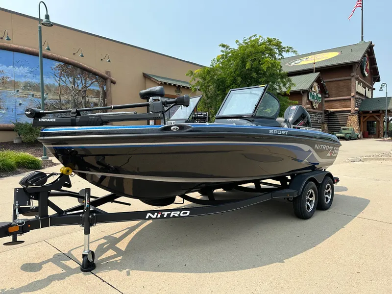 Slide: The Image of 2024 Nitro ZV19 Sport Pro boat on trailer outside a building. - 1