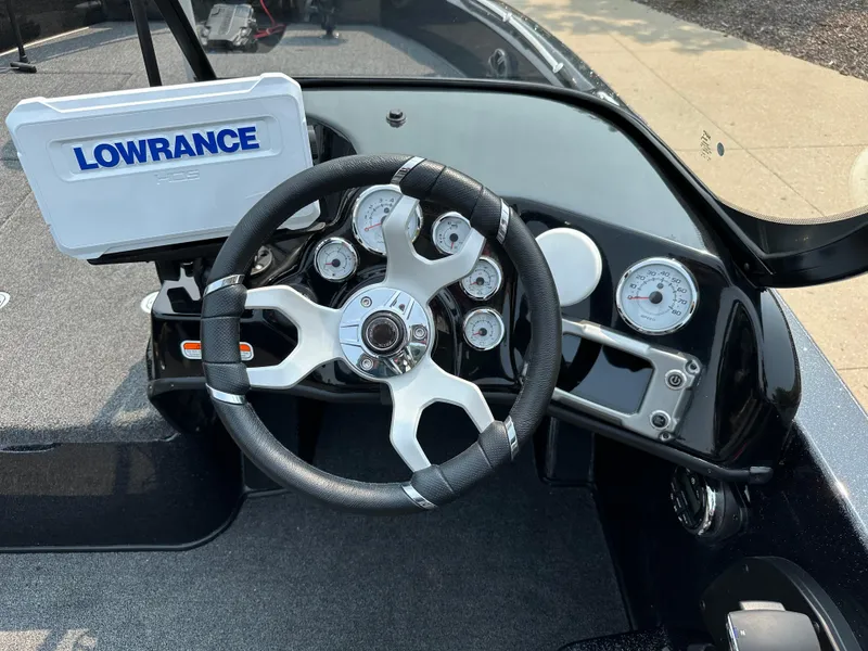 Slide: The Image of 2024 Nitro ZV19 Sport Pro boat dashboard with Lowrance fishfinder and modern steering wheel. - 5