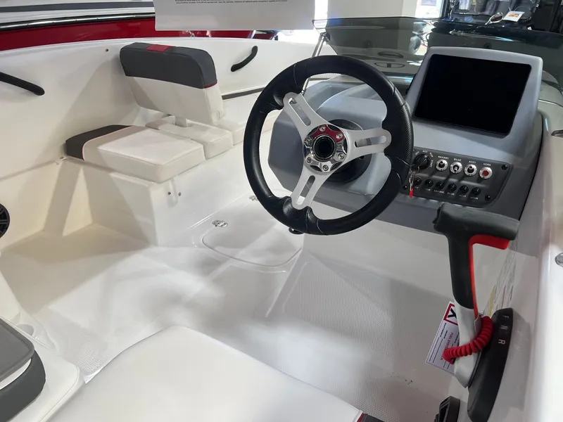 Slide: The Image of 2024 Tahoe T16 boat interior with steering wheel and control panel. - 6