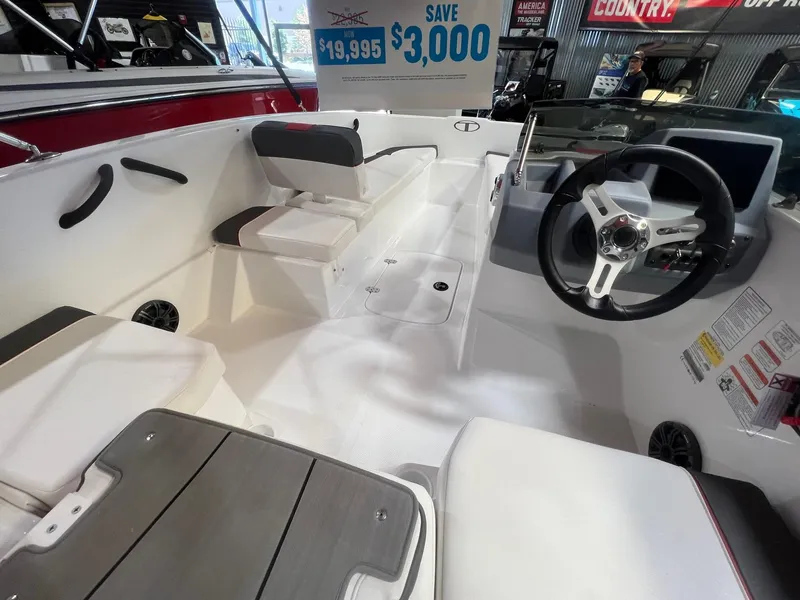Slide: The Image of 2024 Tahoe T16 boat interior with steering wheel, seating, and dashboard, priced at $19,995 with $3,000 savings. - 8
