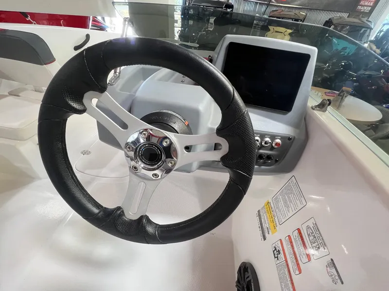 Slide: The Image of Steering wheel and dashboard of a 2024 Tahoe T16 boat. - 9