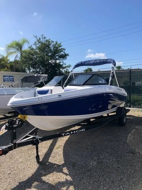 Slide: The Image of 2024 Tahoe 200 S boat on trailer, sunny day, outdoor display. - 2