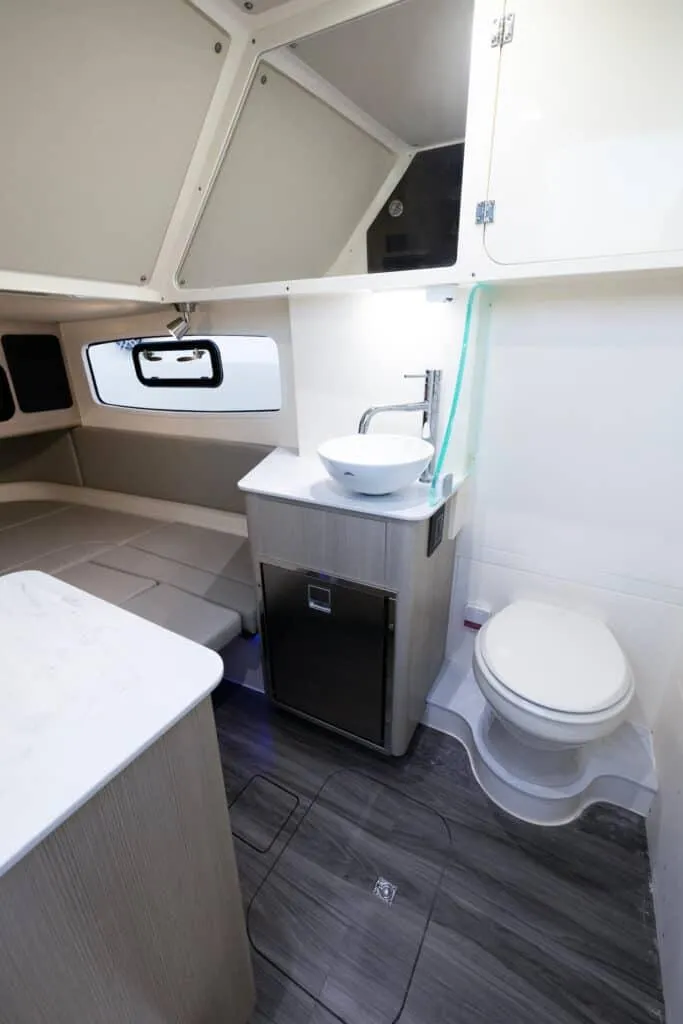 Slide: The Image of 2025 Scout 357 LXF boat interior with modern bathroom and compact design. - 15