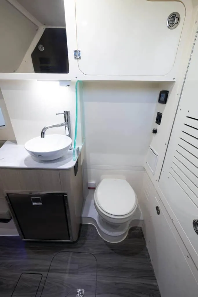 Slide: The Image of 2025 Scout 357 LXF boat bathroom with modern fixtures and storage. - 17