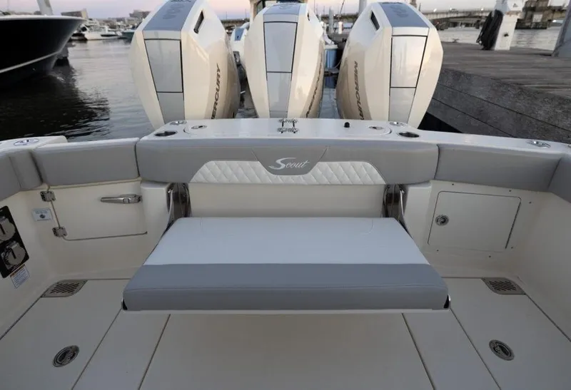 Slide: The Image of 2025 Scout 357 LXF boat with triple outboard engines at dock. - 18