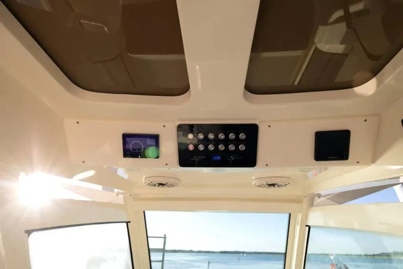 Slide: The Image of 2025 Scout 357 LXF boat interior dashboard with control panel and navigation screen. - 3