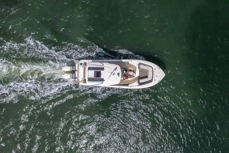 Slide: The Image of Aerial view of 2025 Scout 377 LXF boat cruising on water. - 2
