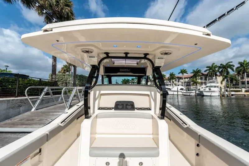 Slide: The Image of 2025 Scout 377 LXF boat docked at marina with palm trees. - 6