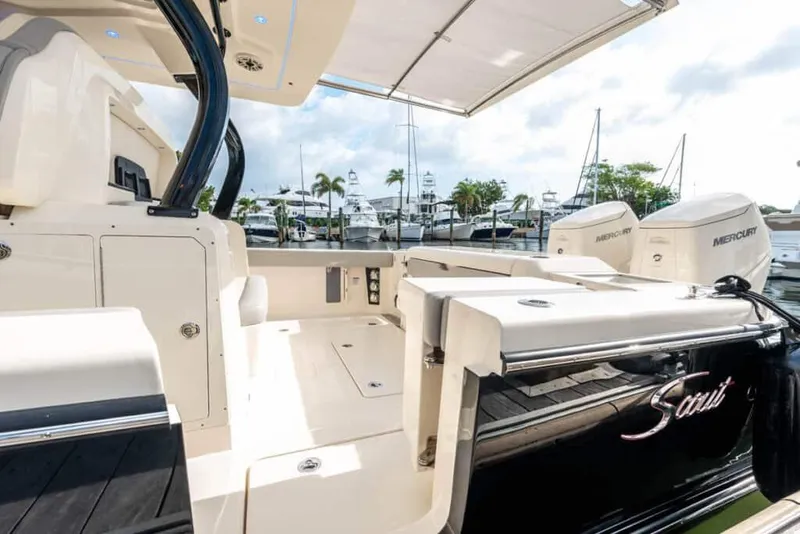Slide: The Image of 2025 Scout 377 LXF luxury boat interior with docked yachts in the background. - 8