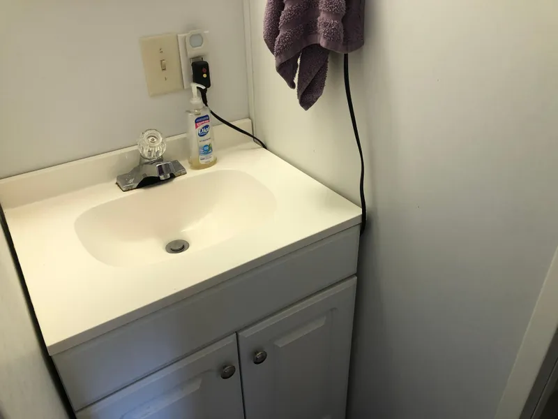 Slide: The Image of Compact bathroom sink in 2013 Catamaran Cruisers 39 boat, with soap dispenser and towel. - 13