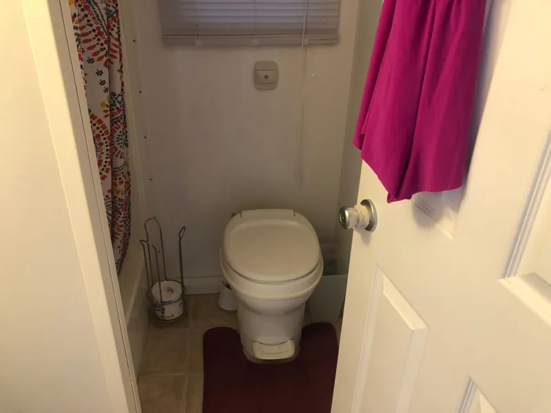 Slide: The Image of Compact bathroom in a 2013 Catamaran Cruisers 39 boat, featuring a toilet and shower. - 15