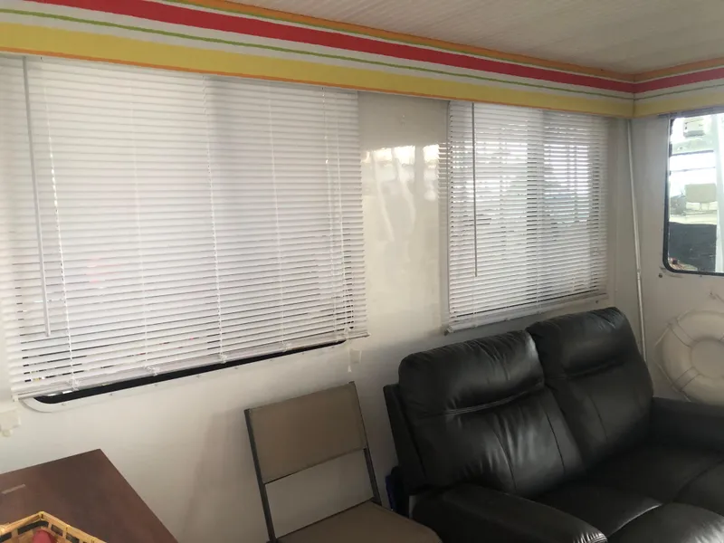 Slide: The Image of Interior of 2013 Catamaran Cruisers 39 with blinds, leather seating, and colorful trim. - 16