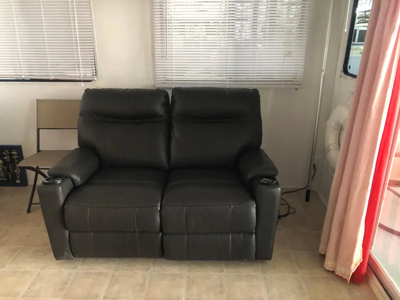 Slide: The Image of Black leather loveseat in a 2013 Catamaran Cruisers 39 boat interior. - 19