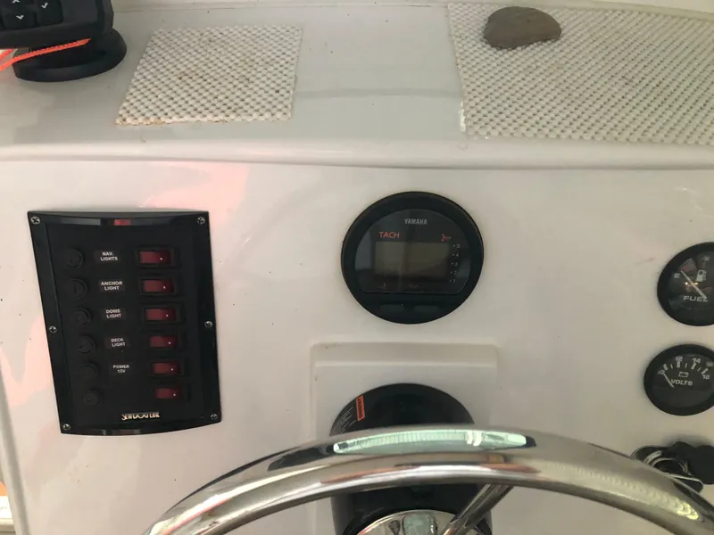 Slide: The Image of Control panel of a 2013 Catamaran Cruisers 39 with gauges and switches. - 21