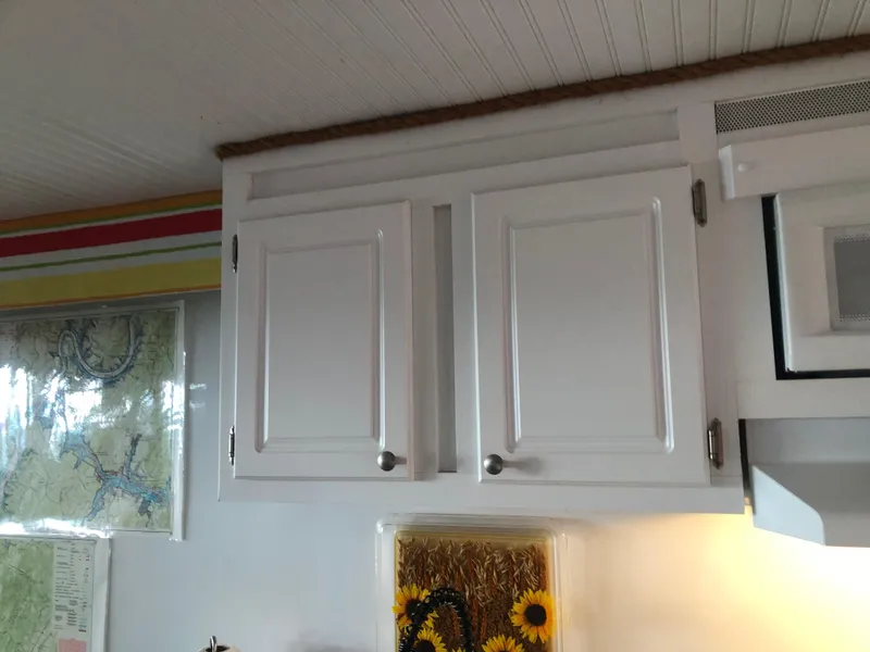 Slide: The Image of White kitchen cabinets in a 2013 Catamaran Cruisers 39 boat. - 25