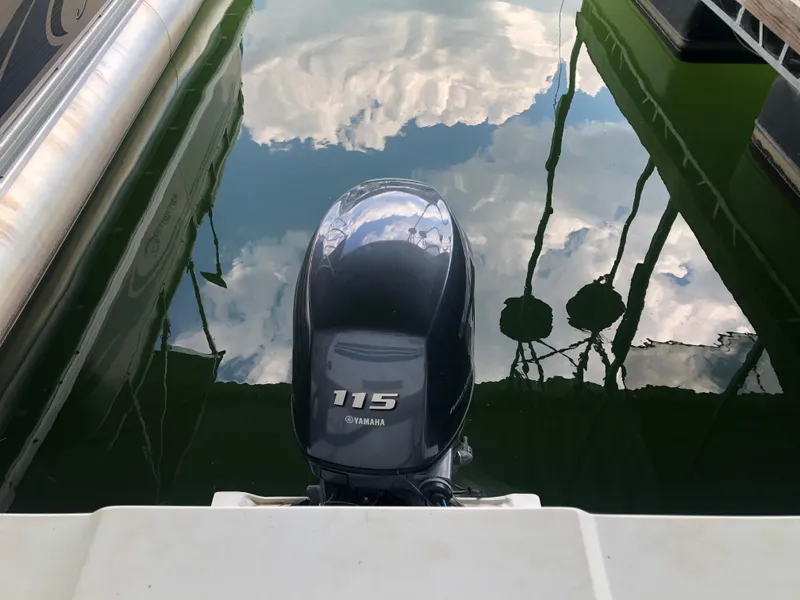 Slide: The Image of Yamaha 115 outboard motor on a 2013 Catamaran Cruisers 39, reflecting in water. - 8