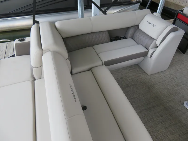 Slide: The Image of 2023 Harris Sunliner 230 boat interior with plush seating and cup holders. - 6