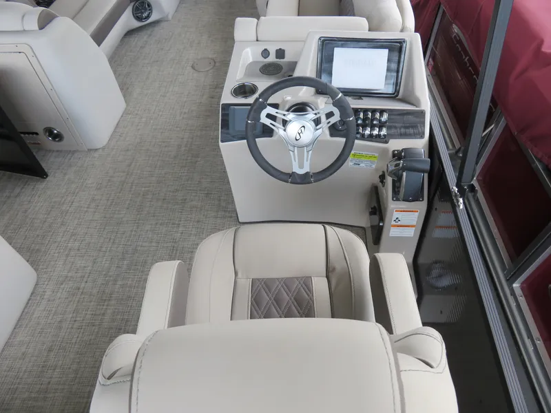 Slide: The Image of 2023 Harris Sunliner 230 boat interior with steering wheel and control panel. - 7