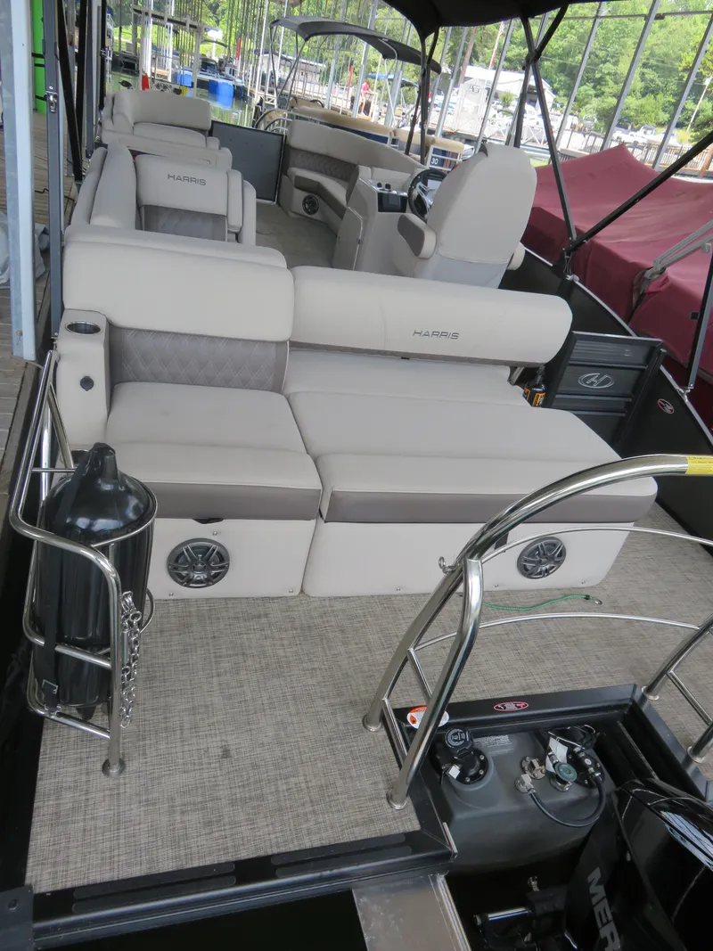 Slide: The Image of 2023 Harris Sunliner 230 pontoon boat with luxurious seating and modern amenities. - 9