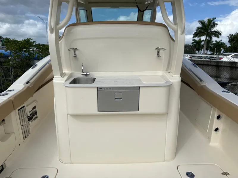 Slide: The Image of 2025 Scout 330 LXF boat interior with sink and storage. - 7