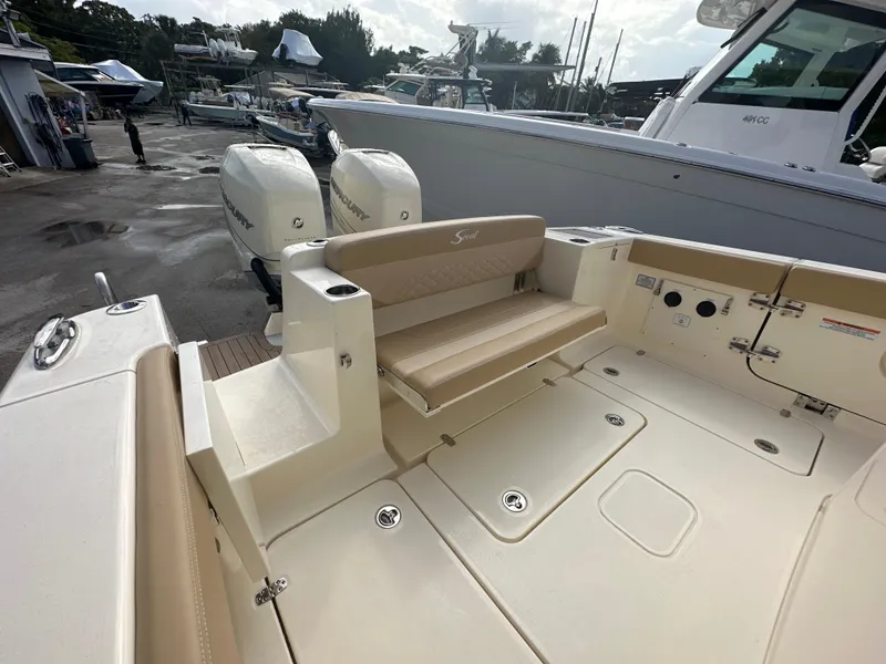 Slide: The Image of 2025 Scout 330 LXF boat with dual outboard engines and spacious deck. - 8