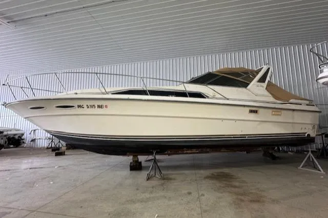 The Image of 1986 Sea Ray 340 Express Cruiser in indoor storage. - 0