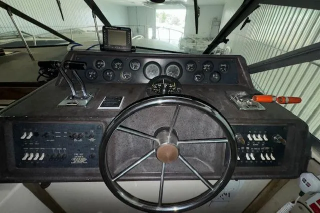 Slide: The Image of 1986 Sea Ray 340 Express Cruiser helm with steering wheel and control panel. - 14
