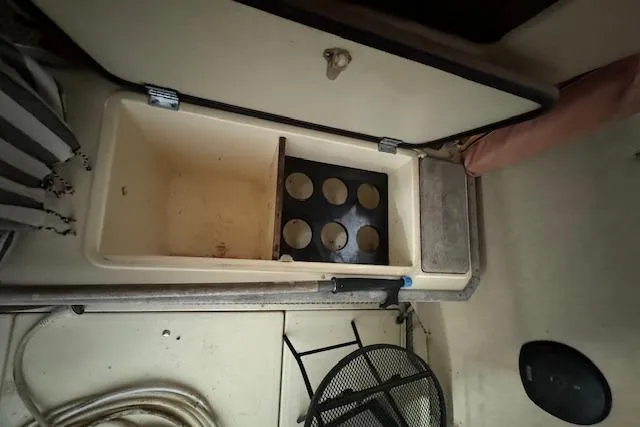 Slide: The Image of 1986 Sea Ray 340 Express Cruiser interior storage compartment and stove. - 18