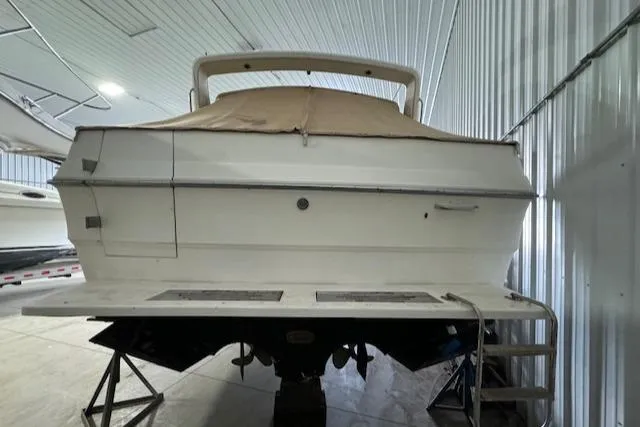 Slide: The Image of 1986 Sea Ray 340 Express Cruiser in storage, rear view. - 2
