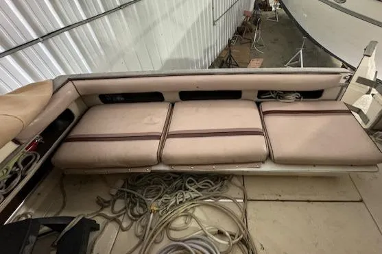 Slide: The Image of 1986 Sea Ray 340 Express Cruiser interior seating area with storage and ropes. - 20