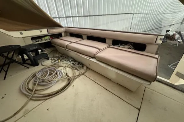 Slide: The Image of 1986 Sea Ray 340 Express Cruiser interior with seating and coiled ropes. - 21