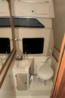 Slide: The Image of 1986 Sea Ray 340 Express Cruiser bathroom with sink and toilet. - 24