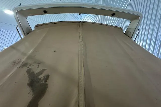 Slide: The Image of 1986 Sea Ray 340 Express Cruiser with tan cover in storage. - 3