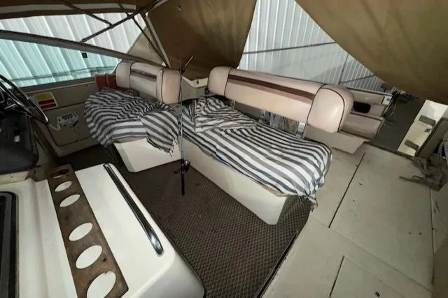 Slide: The Image of 1986 Sea Ray 340 Express Cruiser interior with striped seat covers. - 8