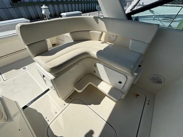 Slide: The Image of 1997 Tiara Yachts 3100 Open interior with cream seating and storage compartments. - 10