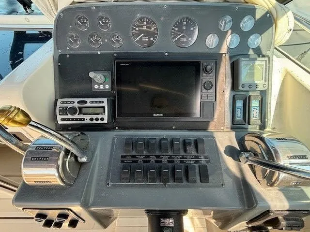 Slide: The Image of 1997 Tiara Yachts 3100 Open dashboard with gauges, controls, and navigation equipment. - 13