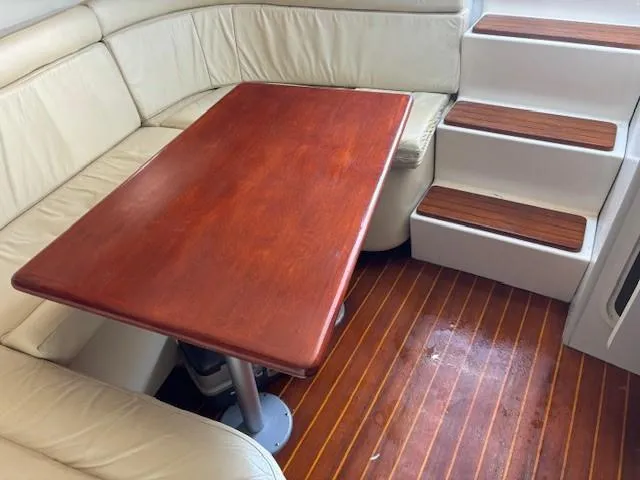 Slide: The Image of 1997 Tiara Yachts 3100 Open interior with wooden table and steps. - 17