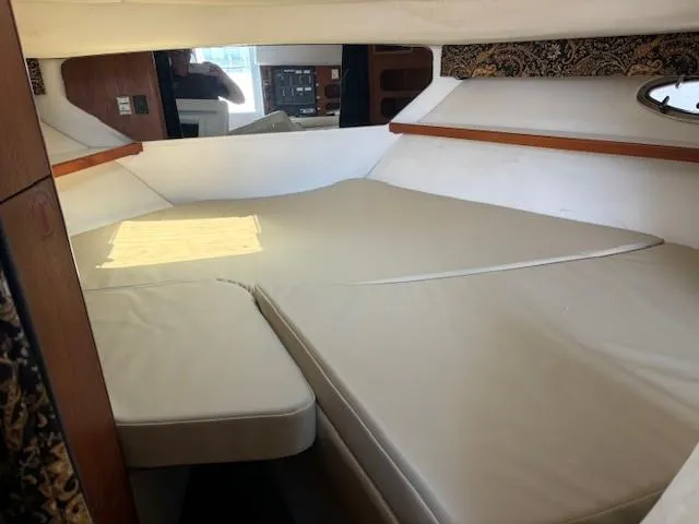 Slide: The Image of 1997 Tiara Yachts 3100 Open cabin interior with beige cushions and wooden accents. - 18