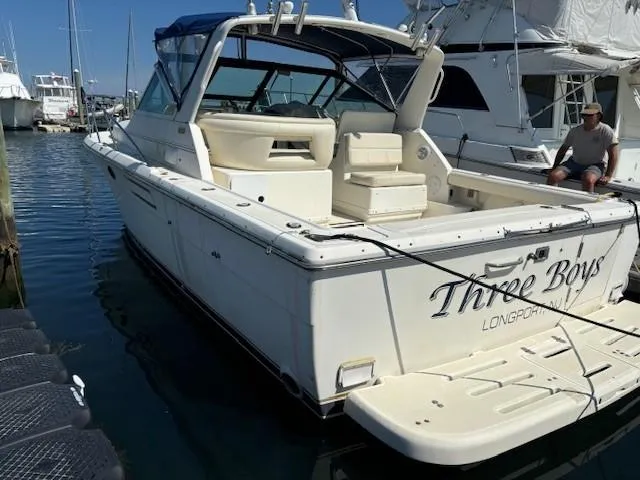 Slide: The Image of 1997 Tiara Yachts 3100 Open docked, featuring spacious deck and seating area. - 2
