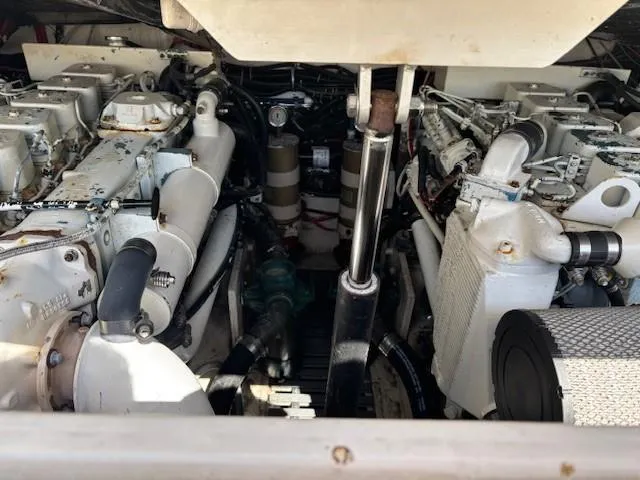 Slide: The Image of Engine compartment of a 1997 Tiara Yachts 3100 Open, showcasing dual engines and mechanical components. - 21