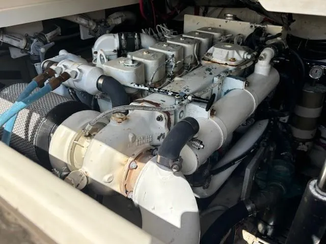 Slide: The Image of Engine compartment of a 1997 Tiara Yachts 3100 Open, showcasing mechanical components and hoses. - 25